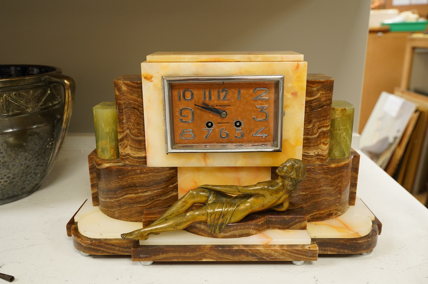 An Art Deco onyx and bronze figural clock, 27cm high. Condition - fair